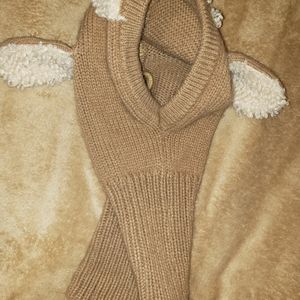 Small child next and head warmer meant to look like a lamb